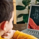 6-7 years cute child learning mathematics from computer