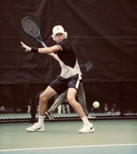 Hardy Owen swinging a tennis racket.